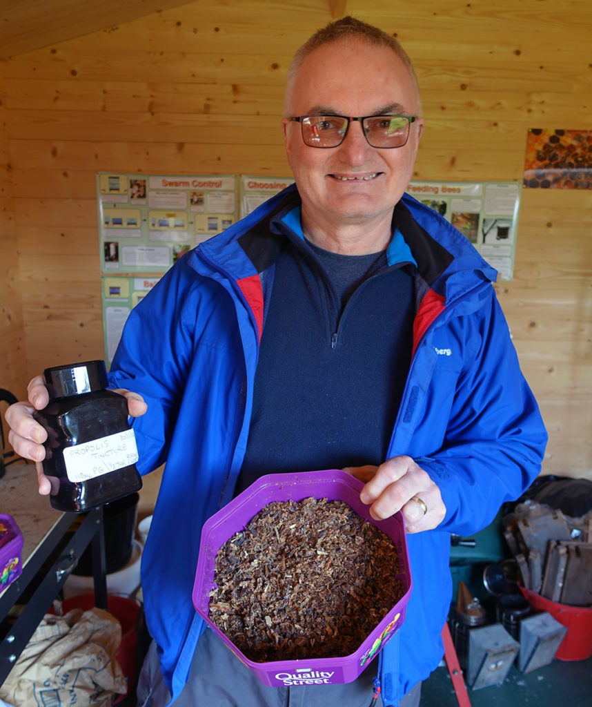 Mick showing the collected propolis to the finished Tincture.